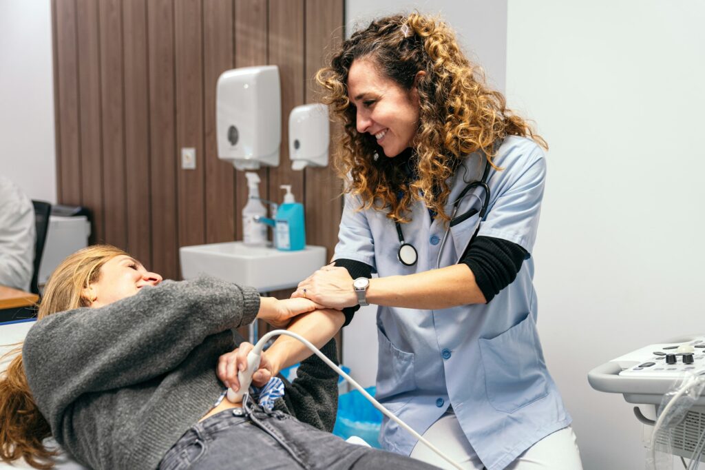 Caring Ultrasound Technician Comforting Patient