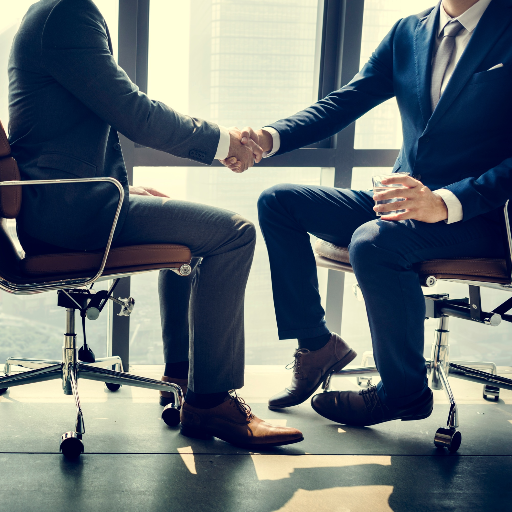 SACC Career Center graduate shaking hands with employer during successful job placement interview