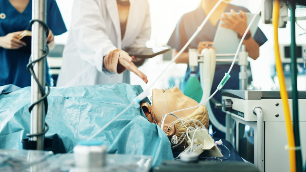 SACC Career Center medical assistant students practicing emergency procedures on simulation mannequin in clinical lab