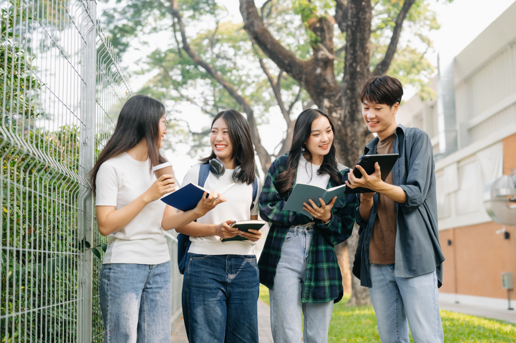 SACC Career Center students studying together outdoors and sharing notes on campus